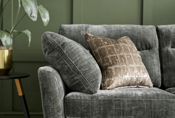 Close-up of grey sofa upholstery and a curved arm