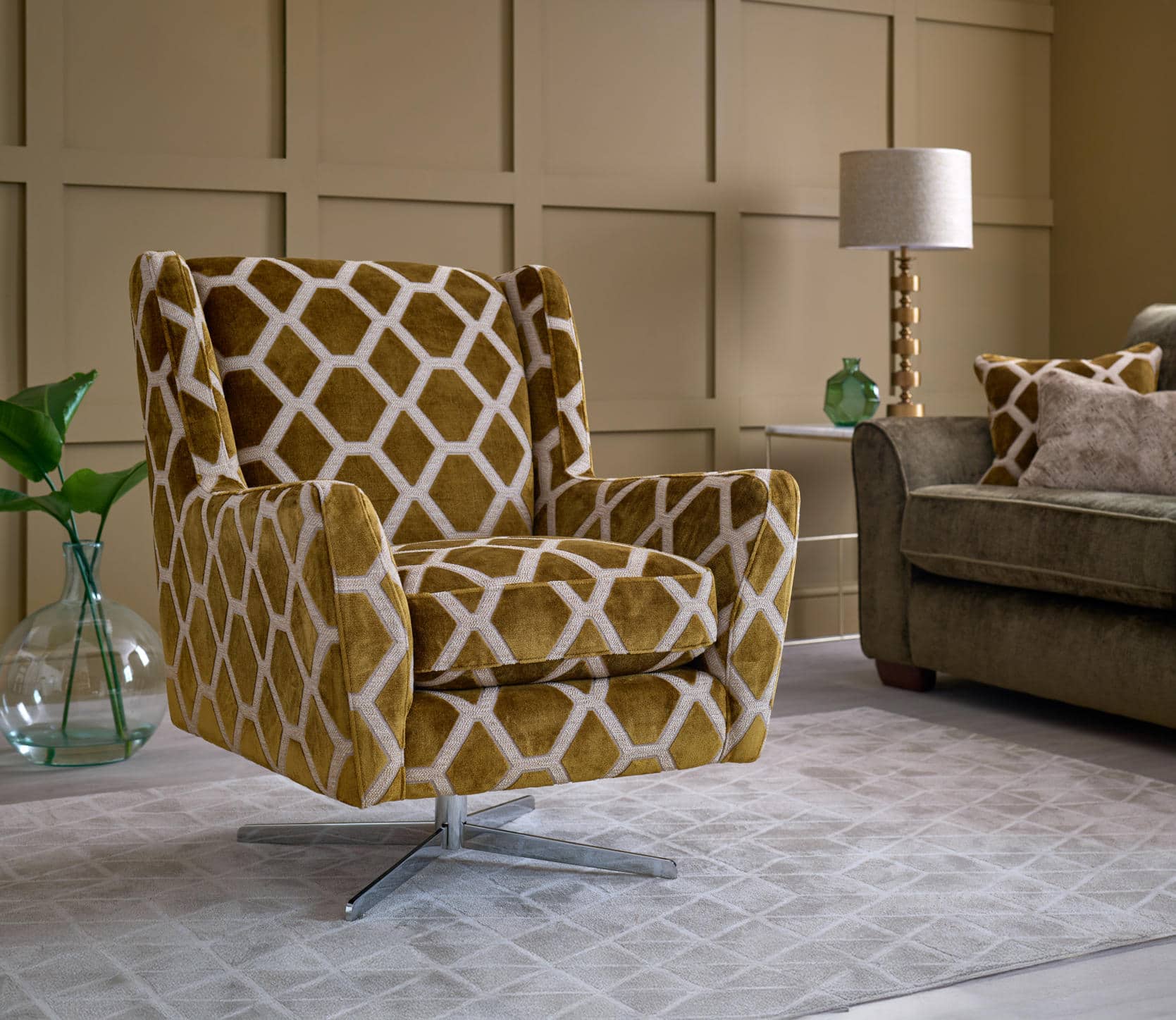 Oddicum swivel chair in gold and cream geometric upholstery beside a sofa.
