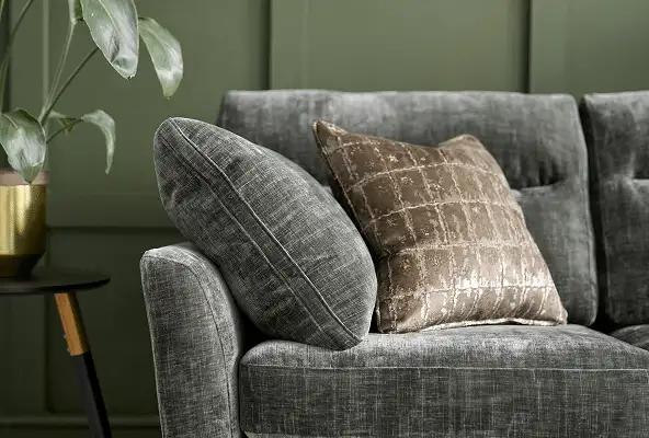 Close-up of grey sofa upholstery and a curved arm