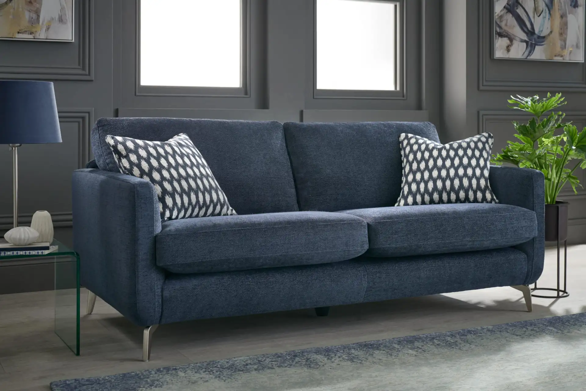 Blue upholstered sofa with patterned cushions in a living room